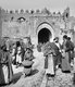 Palestine: Palestinians walking and talking outside the Damascus Gate, Jerusalem, c. 1910